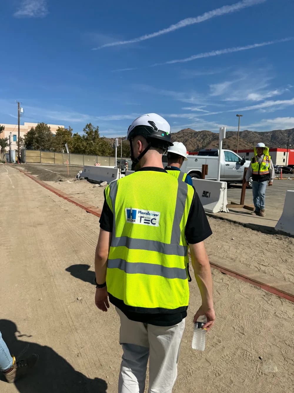A Cogram cofounder visiting a customer's construction site in a hard hat and high-visibility vest.
